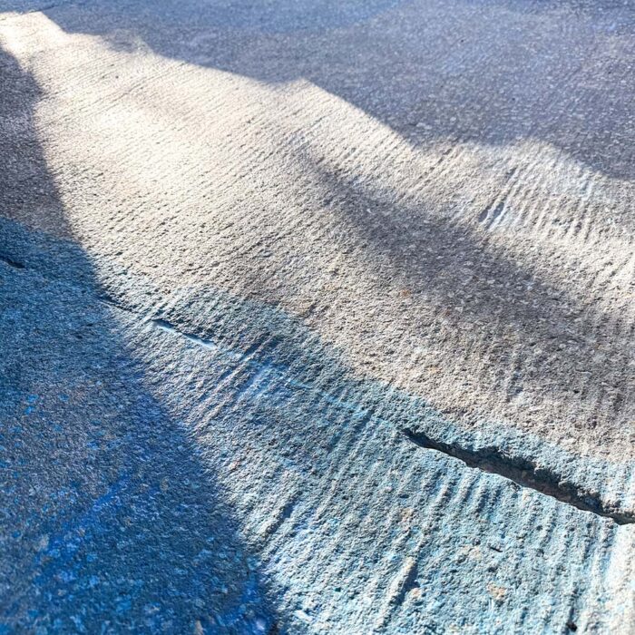 An essential aspect to overlay installation is adhesion. Getting the new concrete overlay to stick to the old concrete is the problem. New concrete will not stick directly to old concrete. As a result, often, overlays will delaminate due to lack of bond from one surface to the other. The answer to fixing this problem is to create a rough surface that supports a mechanical as well as adhesive bonding surface. Use of a Scarfacing Machine followed by an adhesive bonding layer primer and high quality fiber reinforced overlay material insures a solid permanent layer of support for the finish materials.