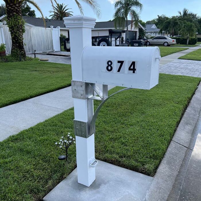 New Mailbox Post with low voltage lighting and Aluminum support structural. Reinforced concrete dowelled into the curb insures a permanent placement.