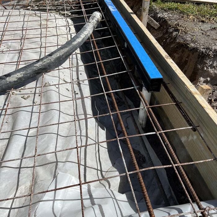 Concrete pad with rebar, heavy mesh and floor Channel Drain