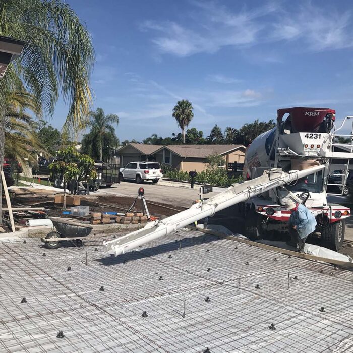 For this project, we were creating a foundation for a paver overlay. First, a reinforced concrete curb was installed which gave us our form for the driveway pavers to sit in. That foundation slab was made up of 4000lb concrete not less than 5 inches in the field and 7 inches on the thickened edge. Reinforced with .29 on 6 inch steel mesh with #5 rebar on the leading edges. This slab, on its own, will last for generations. The finish for this project was an overlay of pavers that gave us a finish that will be resilient and beautiful for generations to come.
