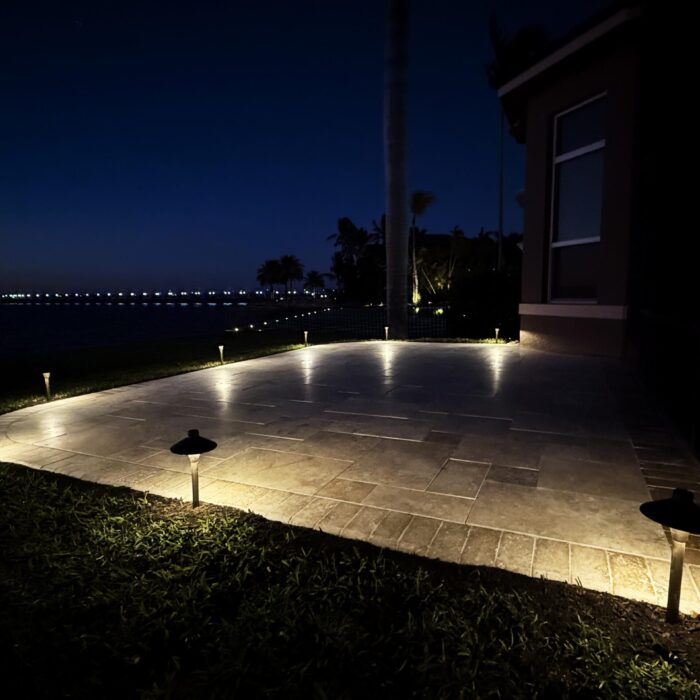 IMG_0941_copy Elegant stone paver patio bordered by low-voltage path lights casting a warm glow through a landscaped yard with the dock lights in the distance a beautiful opportunity for relaxing in the backyard.